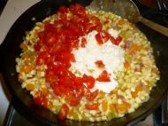 Add tomatoes, garlic and corn milk.