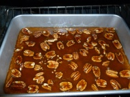 Top the crust with pecans and pour the caramel sauce over.