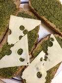 Start your sandwich with pesto and jarlsberg cheese...